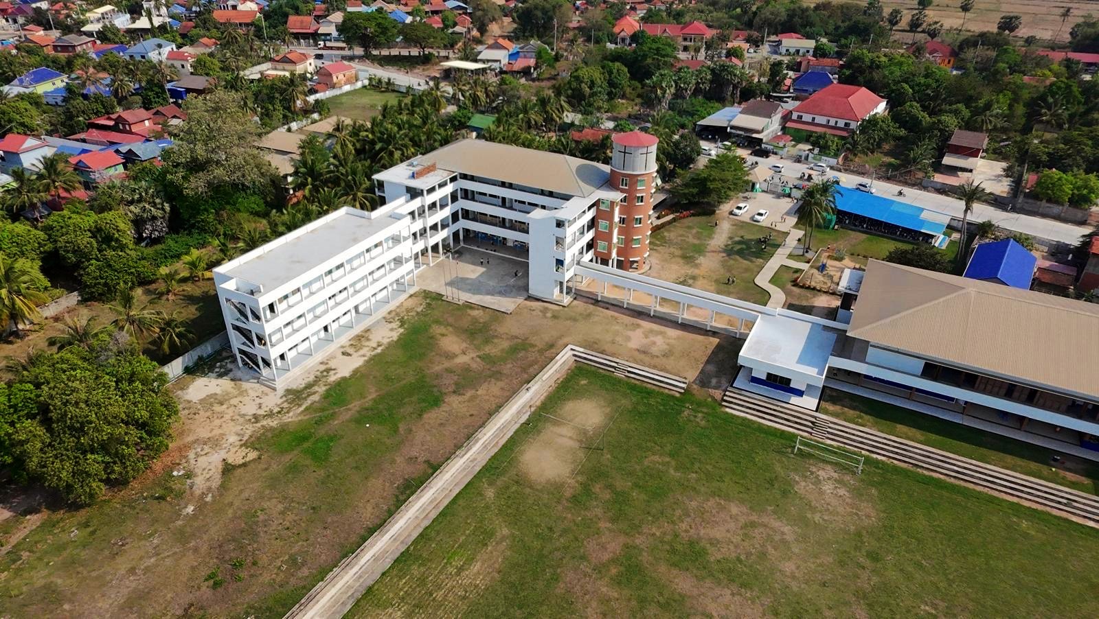 The GTIS campus seen from the air, with the village and rice fields around it
