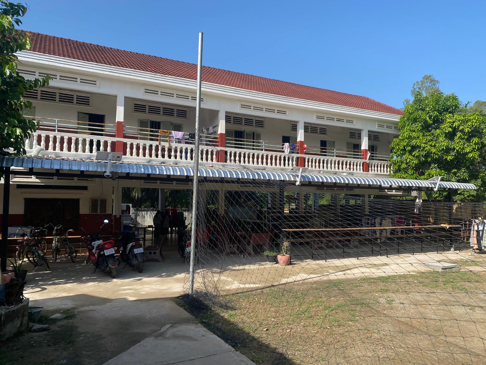 The two-storey dormitory building with its balcony and covered walkway below