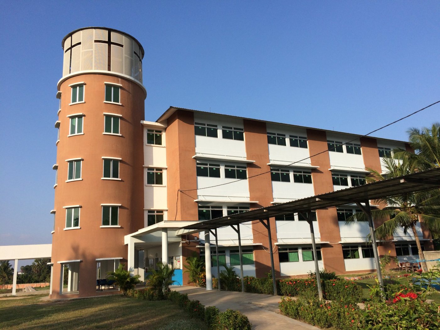 The four-storey classroom block, with the round water tower rising beside its entrance